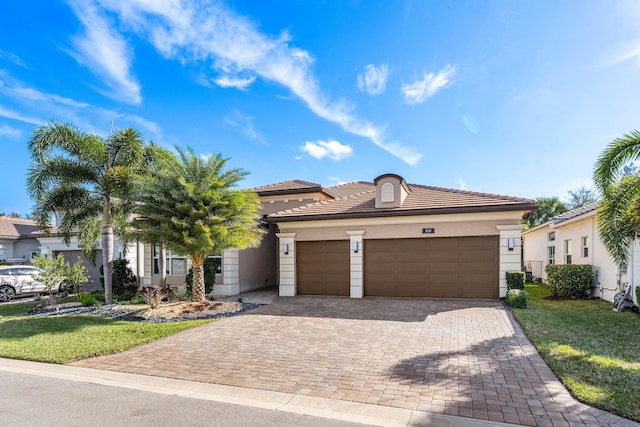 view of front of home with a garage and a front yard