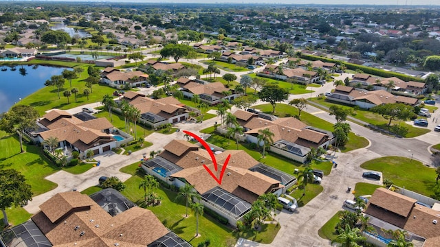 birds eye view of property featuring a water view and a residential view