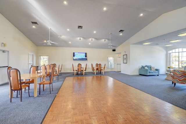 interior space with high vaulted ceiling, visible vents, and baseboards