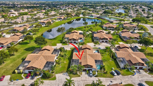 drone / aerial view with a water view and a residential view