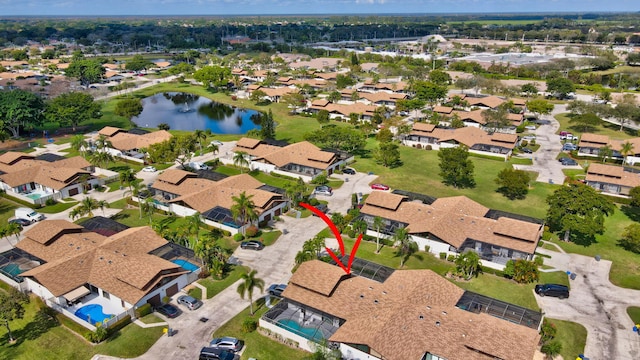 birds eye view of property with a water view and a residential view