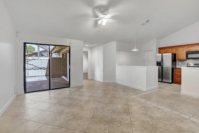 spare room with light tile patterned floors, baseboards, visible vents, vaulted ceiling, and a textured ceiling