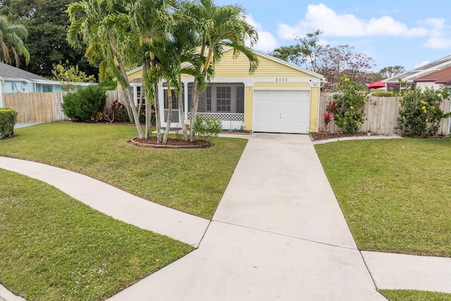 single story home featuring a garage and a front lawn