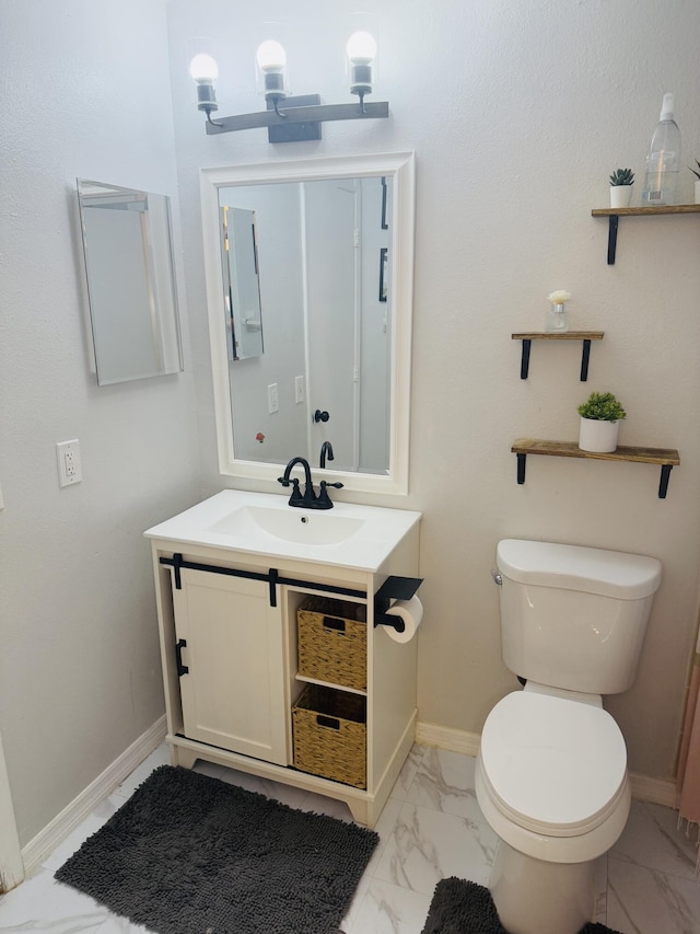 bathroom with toilet and vanity