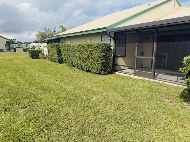 view of yard featuring a sunroom