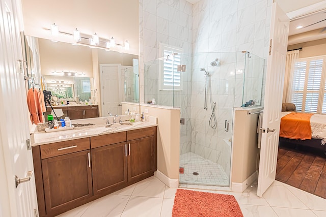 bathroom with tile patterned floors, vanity, and a shower with shower door