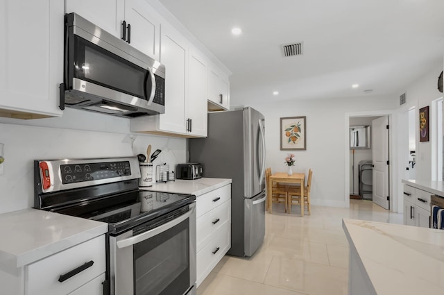 4448 SW 34th Ter, Dania Beach, FL 33312 - kitchen featuring stainless steel appliances, white cabinets, recessed lighting, light tile patterned floors, and light stone countertops