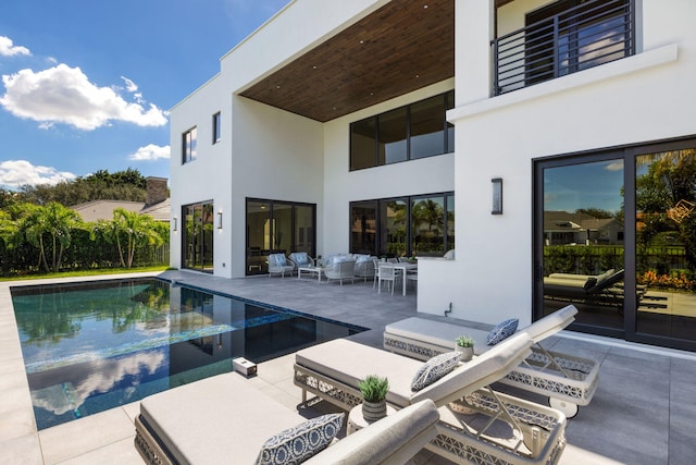 view of swimming pool featuring an outdoor living space and a patio area