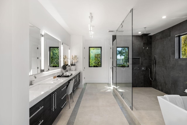 bathroom featuring independent shower and bath and vanity