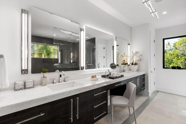 bathroom with vanity, plenty of natural light, and a shower with shower door