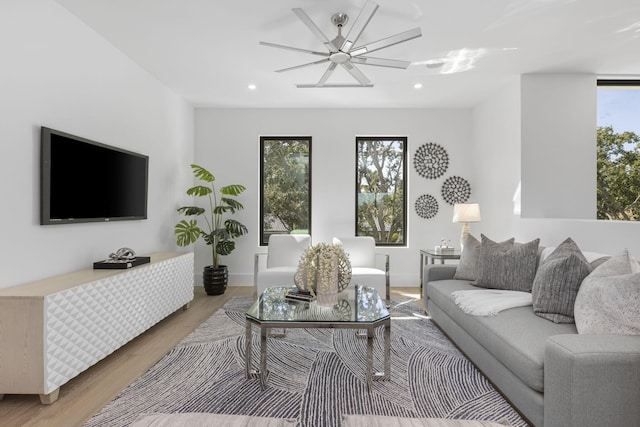 living room with hardwood / wood-style flooring and ceiling fan