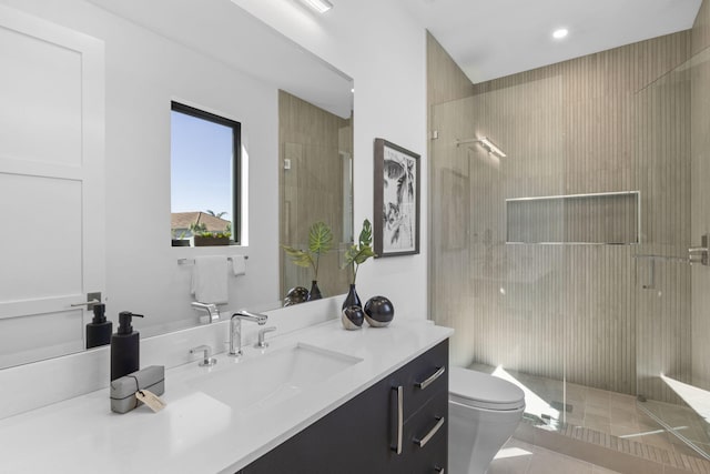 bathroom with walk in shower, vanity, and toilet