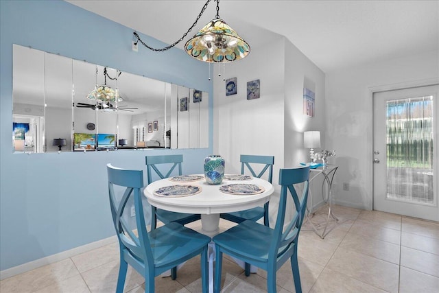 tiled dining space featuring ceiling fan