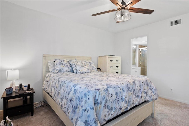 bedroom featuring ceiling fan, ensuite bath, and carpet