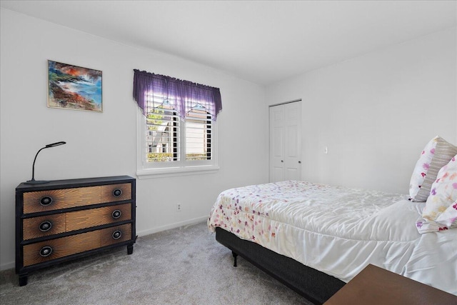 bedroom with light colored carpet and a closet