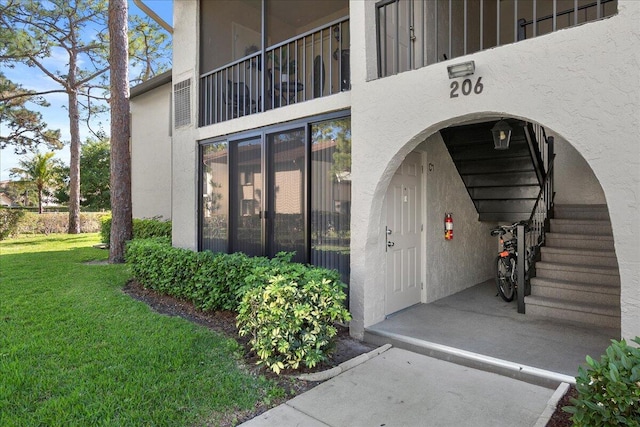 view of exterior entry featuring a yard