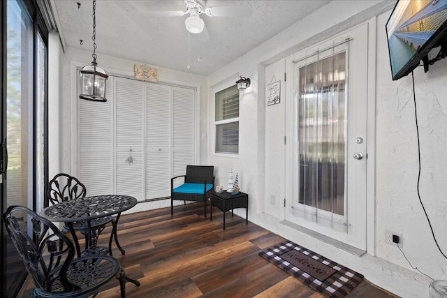 sunroom / solarium featuring ceiling fan