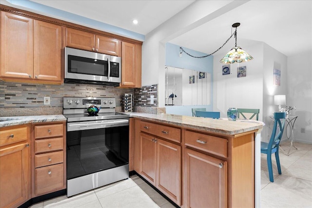 kitchen with backsplash, light stone countertops, kitchen peninsula, and appliances with stainless steel finishes