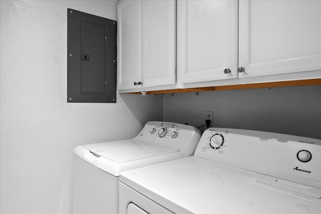 laundry area featuring cabinets, electric panel, and separate washer and dryer