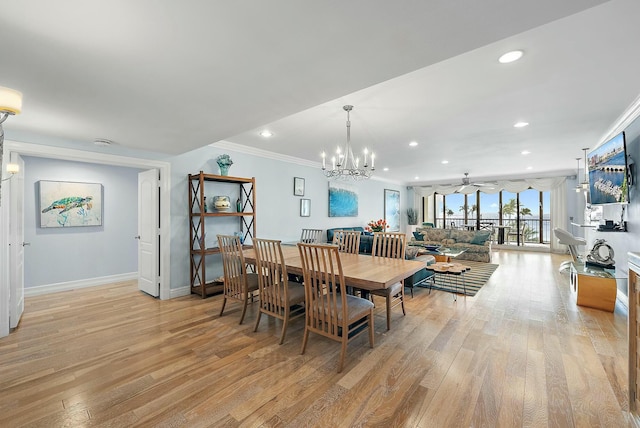 dining room featuring ceiling fan with notable chandelier, ornamental molding, and light hardwood / wood-style floors