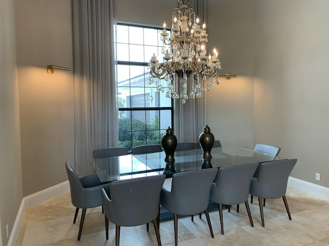 dining area featuring a wealth of natural light and a notable chandelier