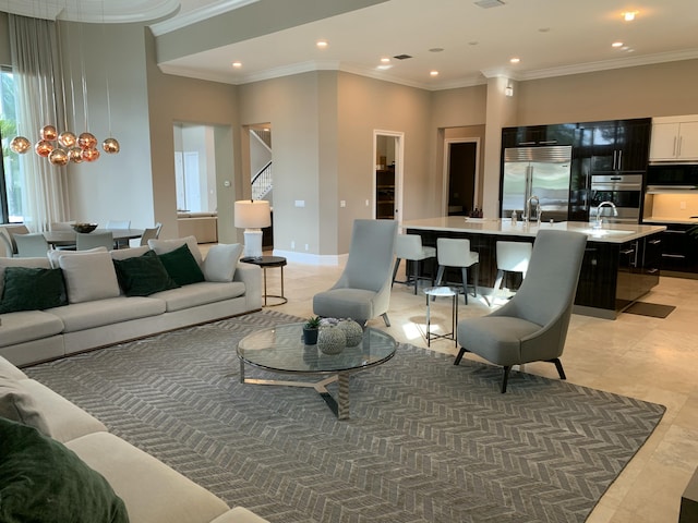 living room featuring sink, ornamental molding, and light tile patterned flooring