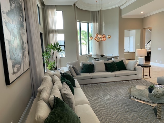 living room featuring crown molding and a towering ceiling