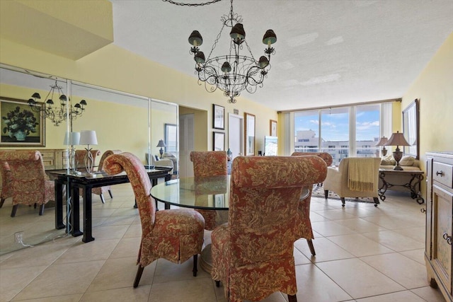 tiled dining area featuring an inviting chandelier, expansive windows, and a textured ceiling