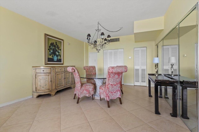 tiled dining area featuring an inviting chandelier