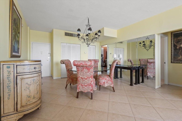 dining space with light tile patterned floors and an inviting chandelier