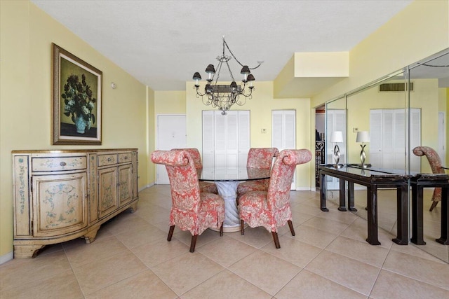 dining area with an inviting chandelier and light tile patterned floors