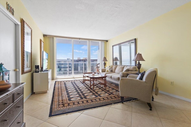 living room featuring light tile patterned floors, expansive windows, and a textured ceiling