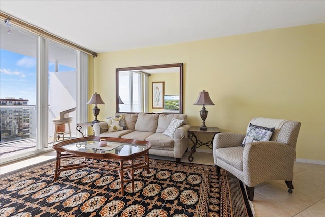 living room featuring tile patterned floors and a wall of windows