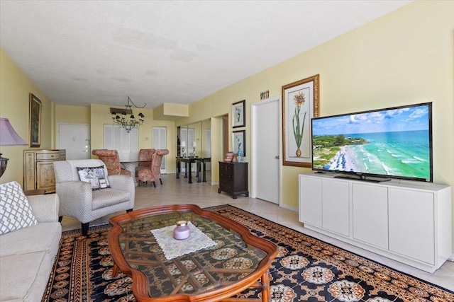 tiled living room with a notable chandelier