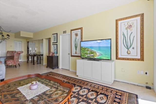 tiled living room featuring a chandelier