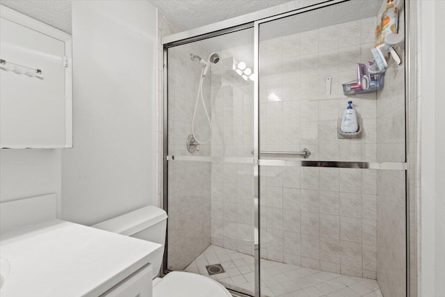 bathroom featuring toilet, a textured ceiling, and walk in shower