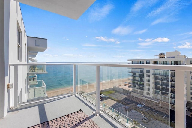 balcony with a water view and a beach view