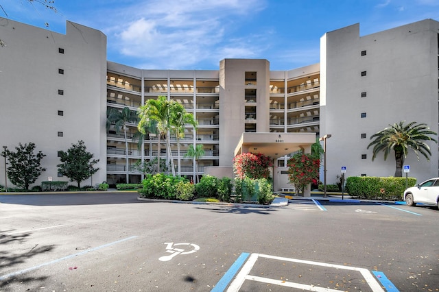 view of building exterior featuring uncovered parking