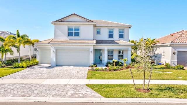 view of front of home featuring a garage and a front lawn