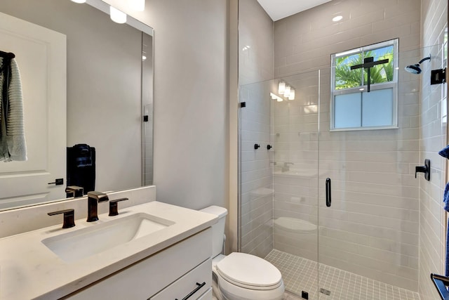 bathroom featuring walk in shower, vanity, and toilet