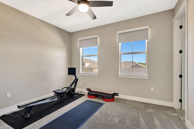 workout room with ceiling fan and light carpet