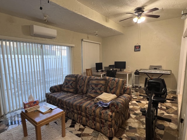 living room featuring ceiling fan, a wall unit AC, and a textured ceiling