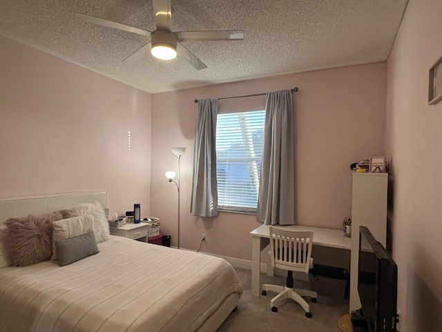 carpeted bedroom with ceiling fan and a textured ceiling