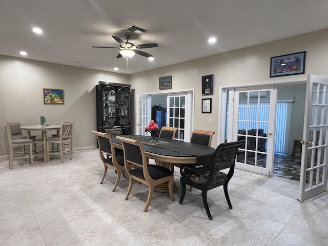 dining room featuring a textured ceiling, ceiling fan, and french doors