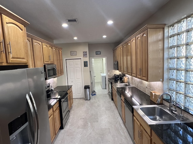 kitchen featuring appliances with stainless steel finishes, sink, and backsplash