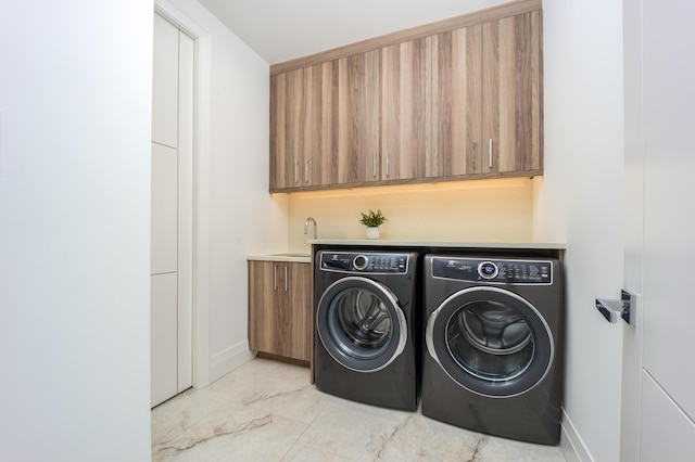 laundry area with cabinets, sink, and independent washer and dryer