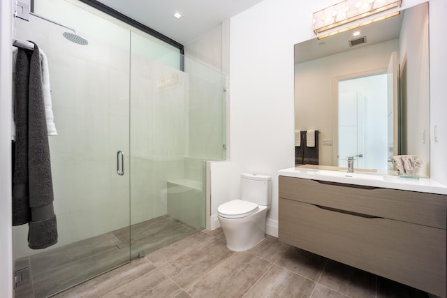 bathroom featuring vanity, an enclosed shower, tile patterned floors, and toilet