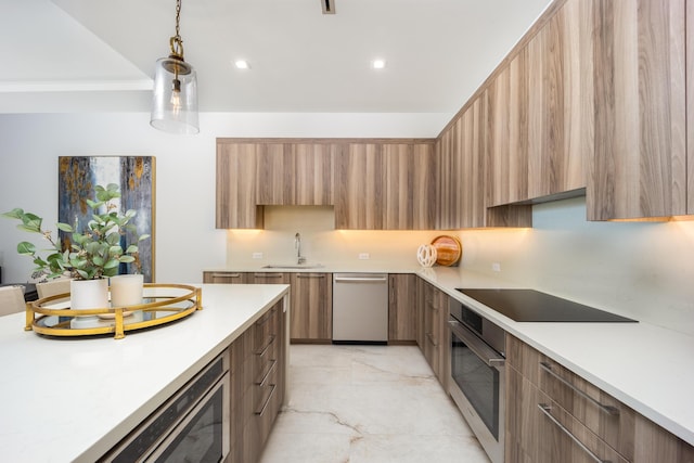 kitchen with hanging light fixtures, appliances with stainless steel finishes, and sink