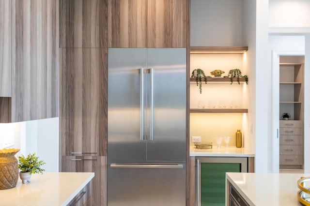 kitchen featuring beverage cooler and stainless steel built in refrigerator