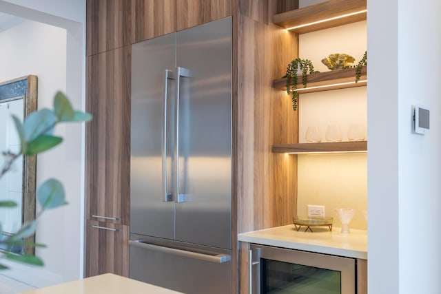 kitchen with beverage cooler and stainless steel built in fridge